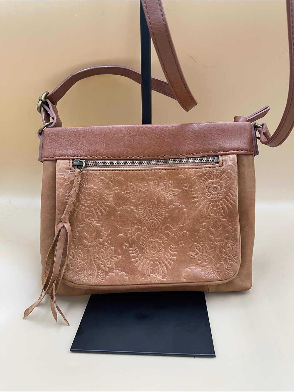 The Sak Women's Embossed Leather Crossbody Bag in Brown with braided pull